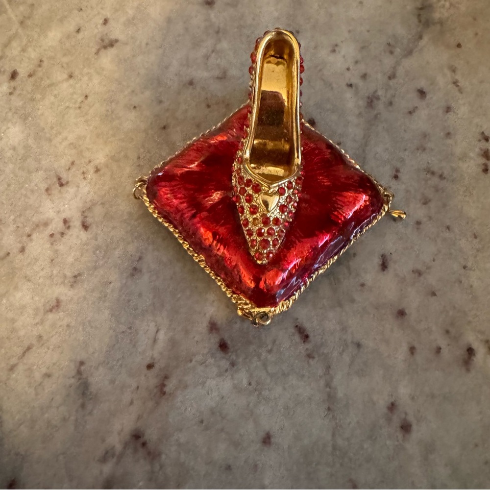 a red and gold shoe with red crystals trinkets